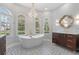 Upscale bathroom featuring standalone tub, designer fixtures, and detailed tile flooring at 23538 Valderama Ln, Sorrento, FL 32776