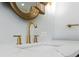 Close-up of bathroom sink with gold faucet and marble countertop at 23538 Valderama Ln, Sorrento, FL 32776
