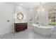 Luxurious bathroom featuring a standalone tub, chandelier, and patterned tile floor at 23538 Valderama Ln, Sorrento, FL 32776