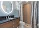 Bathroom with marble countertop vanity and shower with patterned curtain at 23538 Valderama Ln, Sorrento, FL 32776