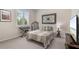 Cozy bedroom featuring a comfy bed, window with shutters, and a decorative wall art at 23538 Valderama Ln, Sorrento, FL 32776