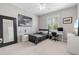 Modern bedroom with a queen bed, shuttered window, stylish decor, and ample natural light at 23538 Valderama Ln, Sorrento, FL 32776