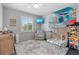 bedroom with a crib, a rocking chair, a fun theme, and a comfortable rug at 23538 Valderama Ln, Sorrento, FL 32776