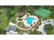 Aerial view of the community pool, tennis courts and surrounding manicured green space at 23538 Valderama Ln, Sorrento, FL 32776