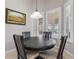 Cozy dining nook with a round wooden table, comfortable seating, and natural light from shuttered windows at 23538 Valderama Ln, Sorrento, FL 32776