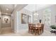 Dining room featuring a wooden table, chandelier, and two framed pictures on the wall at 23538 Valderama Ln, Sorrento, FL 32776