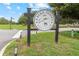 Sign for Eagle Dunes Golf Club, professionally landscaped with beautiful curb appeal at 23538 Valderama Ln, Sorrento, FL 32776