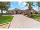 Gorgeous house with a 3-car garage, beautiful landscaping, a paver driveway and walkway at 23538 Valderama Ln, Sorrento, FL 32776