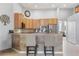 Modern kitchen featuring stainless steel appliances, breakfast bar with seating, and tile backsplash at 23538 Valderama Ln, Sorrento, FL 32776