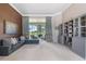 Spacious living area features a comfy sectional couch, bookshelves, and a sliding glass door to the patio at 23538 Valderama Ln, Sorrento, FL 32776