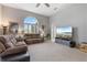 Open living room with large window, ceiling fan, comfortable sofas, and a flat screen television at 23538 Valderama Ln, Sorrento, FL 32776