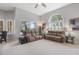Bright living room with high ceilings, comfortable seating, large windows, and natural light at 23538 Valderama Ln, Sorrento, FL 32776