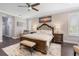 Serene primary bedroom with a king-size bed, elegant decor, and hardwood floors at 23538 Valderama Ln, Sorrento, FL 32776