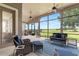Enclosed outdoor patio with cozy seating, ceiling fans, and scenic backyard view at 23538 Valderama Ln, Sorrento, FL 32776