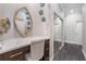 Stylish vanity area with a mirrored closet, a chic mirror, and a sleek countertop at 23538 Valderama Ln, Sorrento, FL 32776