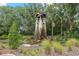 Picturesque water feature with stone accents, surrounded by lush landscaping at 23538 Valderama Ln, Sorrento, FL 32776