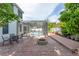 Backyard patio with a screened-in pool area, an outdoor dining table, and fire pit at 2406 Blossomwood Dr, Oviedo, FL 32765