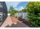 Paver walkway with planters and mulch ground cover lead to a serene backyard at 2406 Blossomwood Dr, Oviedo, FL 32765