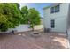 Paver patio with fire pit and outdoor dining set, surrounded by lush greenery and privacy fence at 2406 Blossomwood Dr, Oviedo, FL 32765