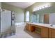 Bathroom featuring a large mirror, a walk in shower, a soaking tub, and dual vanities at 2406 Blossomwood Dr, Oviedo, FL 32765