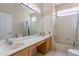 Bathroom features dual sinks and a shower-tub combo with marble countertops and neutral tile at 2406 Blossomwood Dr, Oviedo, FL 32765