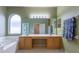 This primary bath features double sinks, an arched window above a soaking tub, and separate glass shower at 2406 Blossomwood Dr, Oviedo, FL 32765