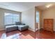 Sitting room with hardwood floors, a window with blinds, and a glimpse of the bathroom at 2406 Blossomwood Dr, Oviedo, FL 32765
