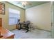 This bedroom features a modern tile floor, neutral walls, and a ceiling fan above a desk at 2406 Blossomwood Dr, Oviedo, FL 32765