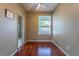 Cozy bedroom featuring a hardwood floor, window with view, and access to a full ensuite bathroom at 2406 Blossomwood Dr, Oviedo, FL 32765