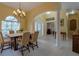 Inviting dining area featuring a chandelier, arched entryway, and decorative pillars at 2406 Blossomwood Dr, Oviedo, FL 32765