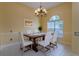 Cozy dining room with a modern chandelier and a window providing natural light at 2406 Blossomwood Dr, Oviedo, FL 32765