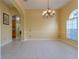 Spacious dining room with tile flooring, a chandelier, and an arched window at 2406 Blossomwood Dr, Oviedo, FL 32765