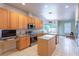 Well-lit kitchen with an island, stainless steel appliances, granite countertops, and ample cabinet space at 2406 Blossomwood Dr, Oviedo, FL 32765