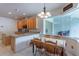Kitchen featuring granite counters, tile flooring, and an adjacent breakfast area with window at 2406 Blossomwood Dr, Oviedo, FL 32765