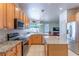 Bright kitchen with granite countertops, stainless appliances, and a view into the living area at 2406 Blossomwood Dr, Oviedo, FL 32765