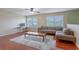 Bright living room featuring hardwood floors, comfortable seating, natural light, and ceiling fan at 2406 Blossomwood Dr, Oviedo, FL 32765