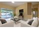 Contemporary living room with backyard views, neutral walls and stylish white sofas at 2406 Blossomwood Dr, Oviedo, FL 32765