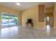 Cozy living room with tile flooring, a television, and sliding glass doors leading to the pool at 2406 Blossomwood Dr, Oviedo, FL 32765