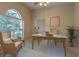 Bright office space featuring a ceiling fan, large window, and comfortable seating at 2406 Blossomwood Dr, Oviedo, FL 32765