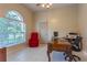 Home office featuring tile flooring, a ceiling fan, a large window, and a comfortable chair at 2406 Blossomwood Dr, Oviedo, FL 32765