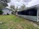 The backyard features a screened porch, grass, and a storage building at 255 Belinda Dr, Deland, FL 32720