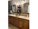 Farmhouse bathroom features custom wood design with updated cabinets and double sink at 255 Belinda Dr, Deland, FL 32720