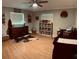 This bedroom has a rustic decorative theme with a ceiling fan and wood laminate floors at 255 Belinda Dr, Deland, FL 32720