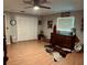 This bedroom has a rustic decorative theme with a ceiling fan, closet, and wood laminate floors at 255 Belinda Dr, Deland, FL 32720
