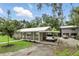 Wide view of home showing carport, well-maintained lawn, second structure, and ample parking at 255 Belinda Dr, Deland, FL 32720