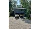 Exterior shot of property featuring a two-story building with two boats parked in front of the garage at 255 Belinda Dr, Deland, FL 32720