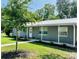 Charming single-story home featuring a metal roof, neutral gray color, tidy landscaping, and a welcoming walkway at 255 Belinda Dr, Deland, FL 32720