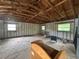 Unfinished interior of property showcasing exposed ceiling beams, cinderblock walls, and small windows at 255 Belinda Dr, Deland, FL 32720