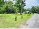 The long lot offers a large yard, mature trees, and a custom storage building at 255 Belinda Dr, Deland, FL 32720