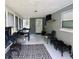 The enclosed porch has a ceiling fan, tv, and provides a versatile outdoor space at 255 Belinda Dr, Deland, FL 32720